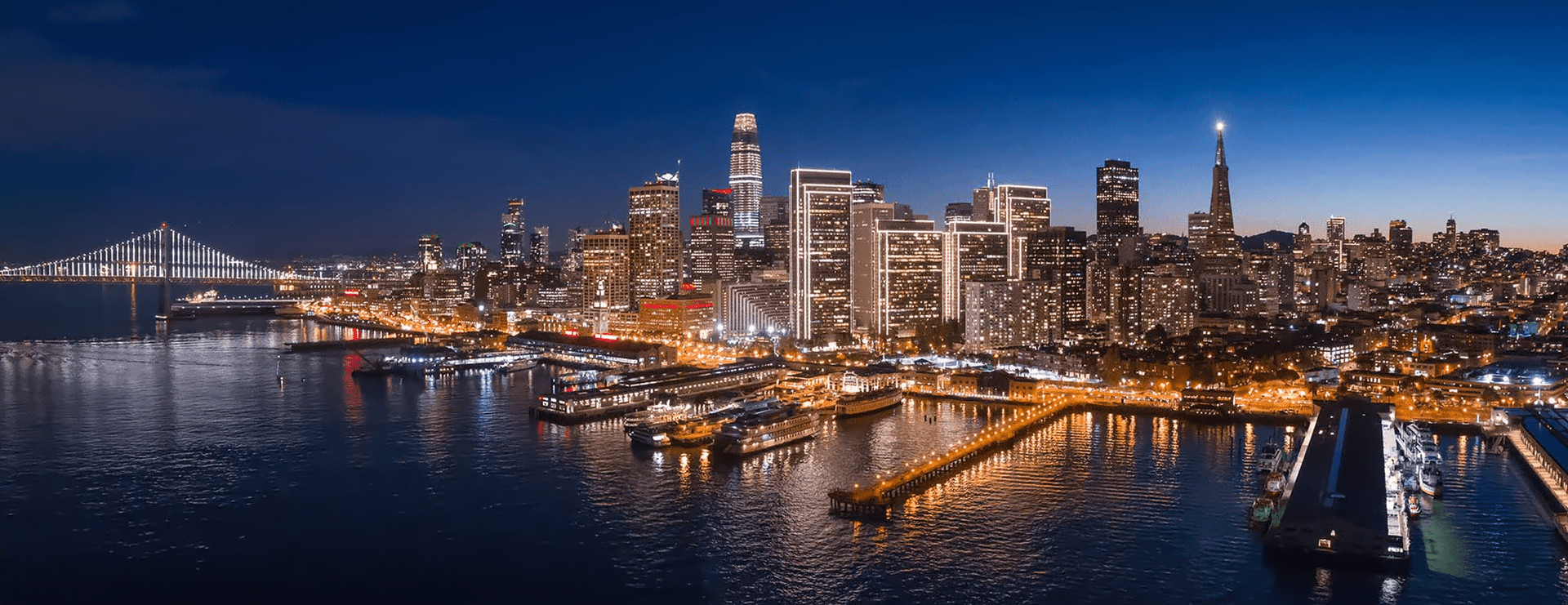 Views of San Francisco: the waterfront skyline at night, the Bay Bridge with the downtown skyline, and the Blue Angels flying in formation